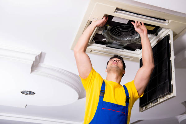 Canva-Repairing-Ceiling-Air-Conditioning-Unit-scaled-e1591368170632.jpg